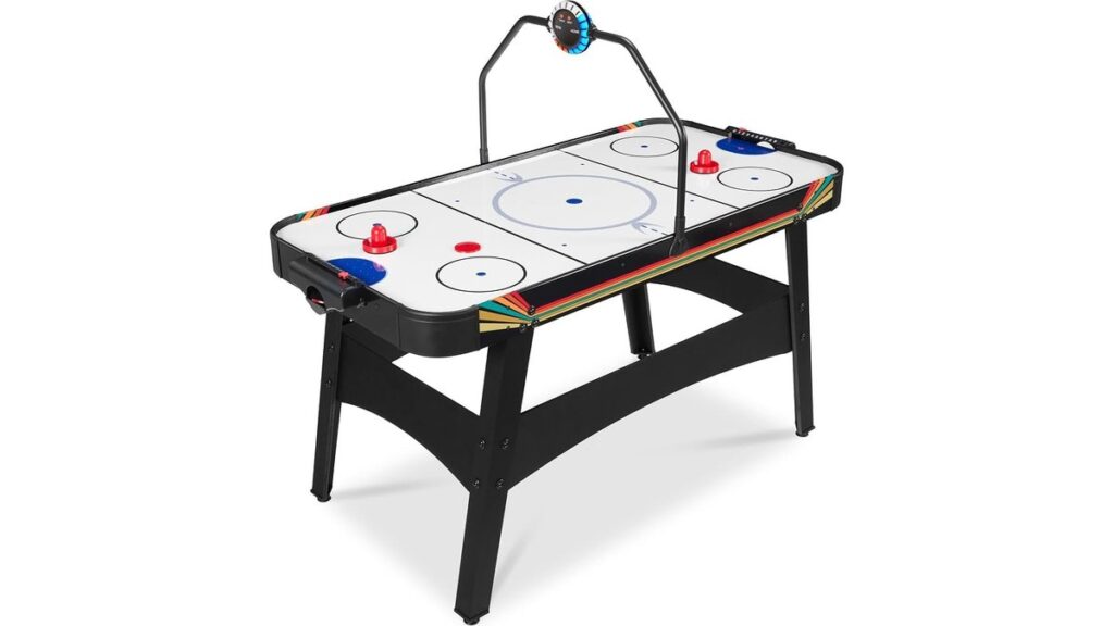 A durable black three-inch air hockey puck sits on a professional game table surface.